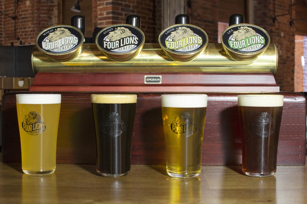 Branding on brewery taps and glasses.